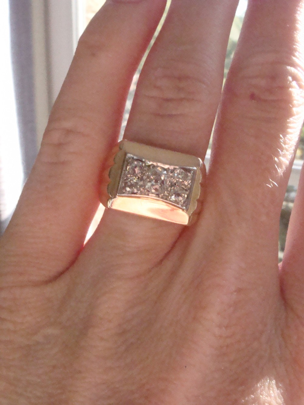 An 18ct yellow gold tank ring featuring a rectangular platinum panel set with bright diamonds. View VI