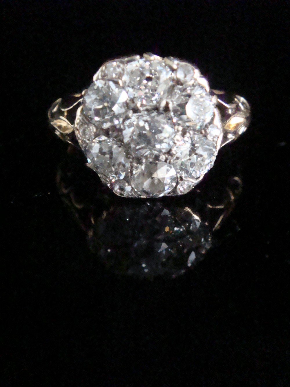 Victorian 18ct yellow gold ring featuring a multi-diamond cluster head and ornate scrollwork shoulders. View II