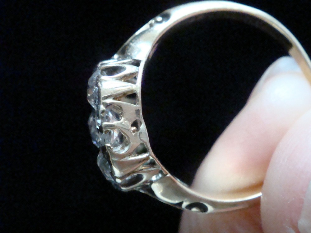 Victorian 18ct yellow gold ring featuring a multi-diamond cluster head and ornate scrollwork shoulders. View VI