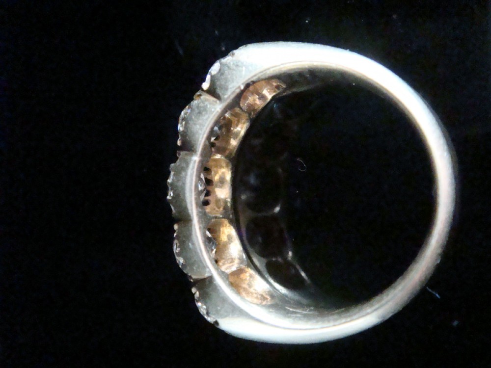 An early Victorian 18ct yellow gold ring featuring five graduated old-cut diamonds set horizontally along a carved gallery. View XII
