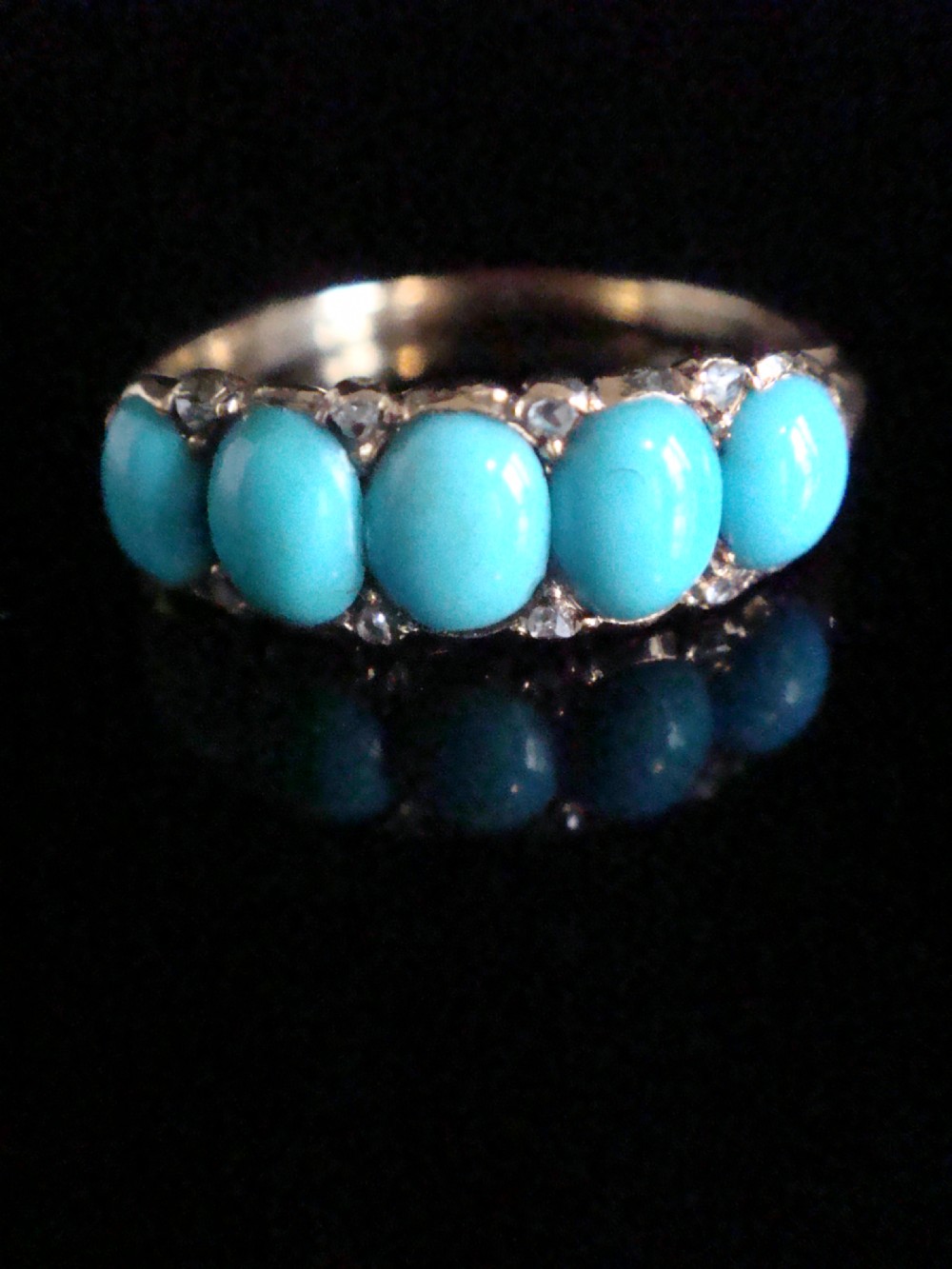 Victorian 18ct yellow gold five-stone ring set with vibrant turquoise cabochons and diamond accents.