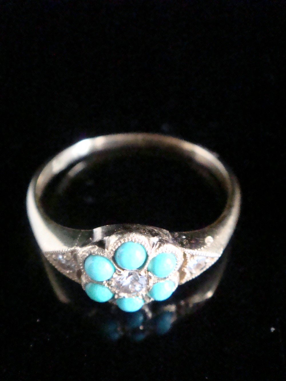 A Victorian 18ct yellow gold cluster ring featuring a central diamond surrounded by six turquoise cabochons with milgrain-detailed shoulders. View III