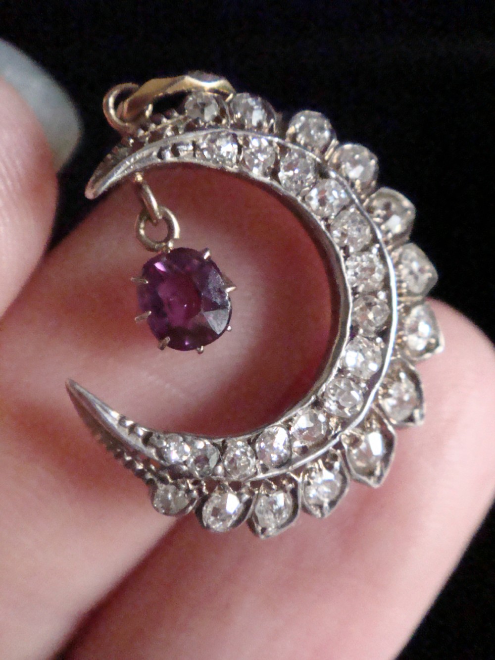 Victorian crescent moon pendant crafted in platinum and 18ct yellow gold, set with diamonds and a central suspended ruby. View V