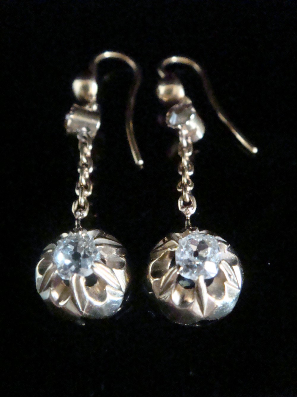 Victorian 18ct yellow gold drop earrings featuring old cut diamonds set within starburst crimped collet settings suspended from fine chains. View III