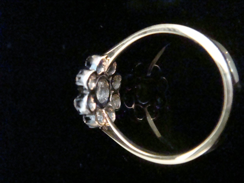 A Victorian 18ct yellow gold cluster ring featuring old mine cut diamonds arranged in a floral formation. View III