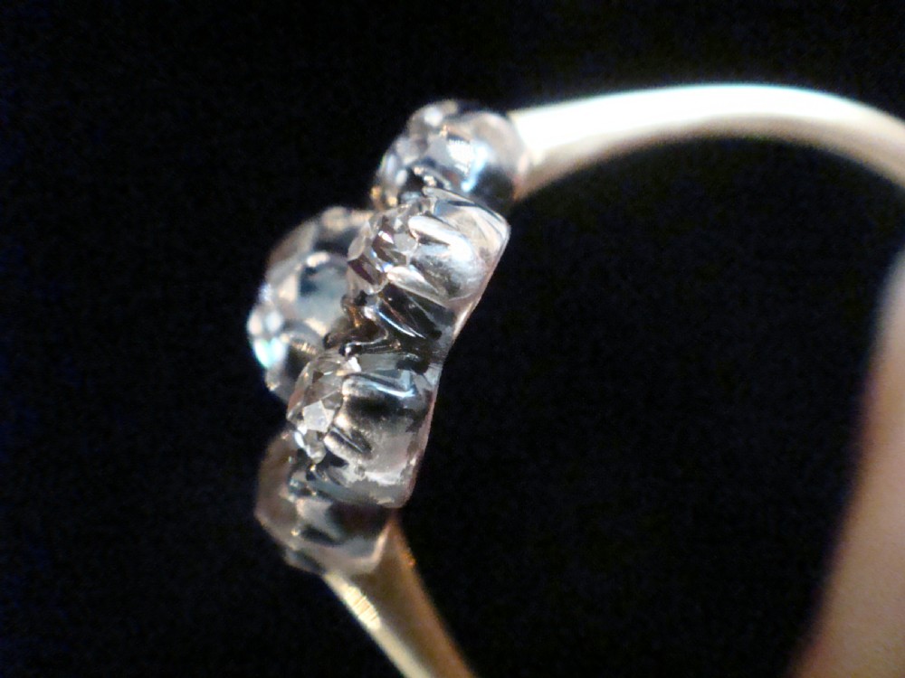 A Victorian 18ct yellow gold cluster ring featuring old mine cut diamonds arranged in a floral formation. View IV