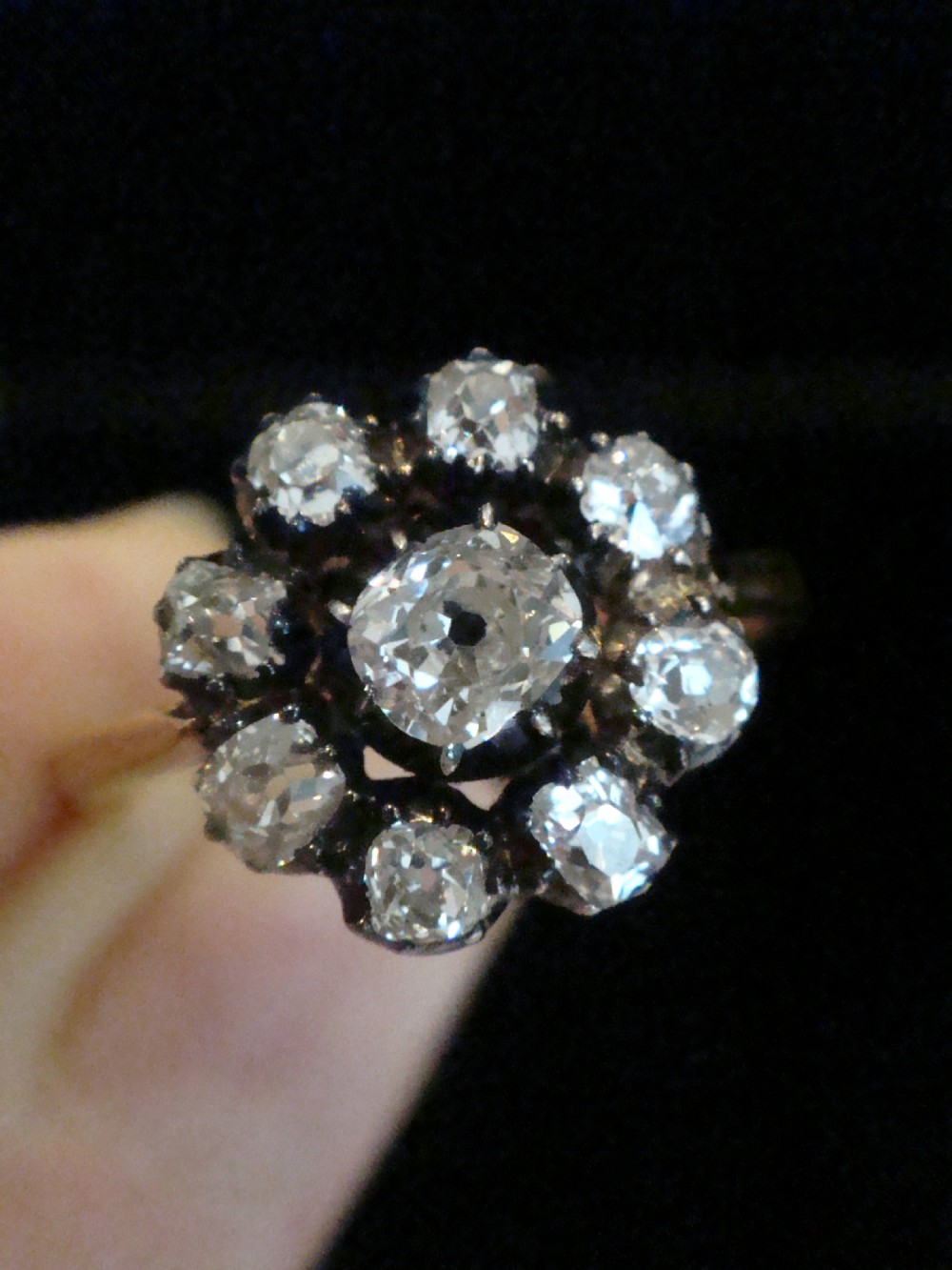 A Victorian 18ct yellow gold cluster ring featuring old mine cut diamonds arranged in a floral formation. View V