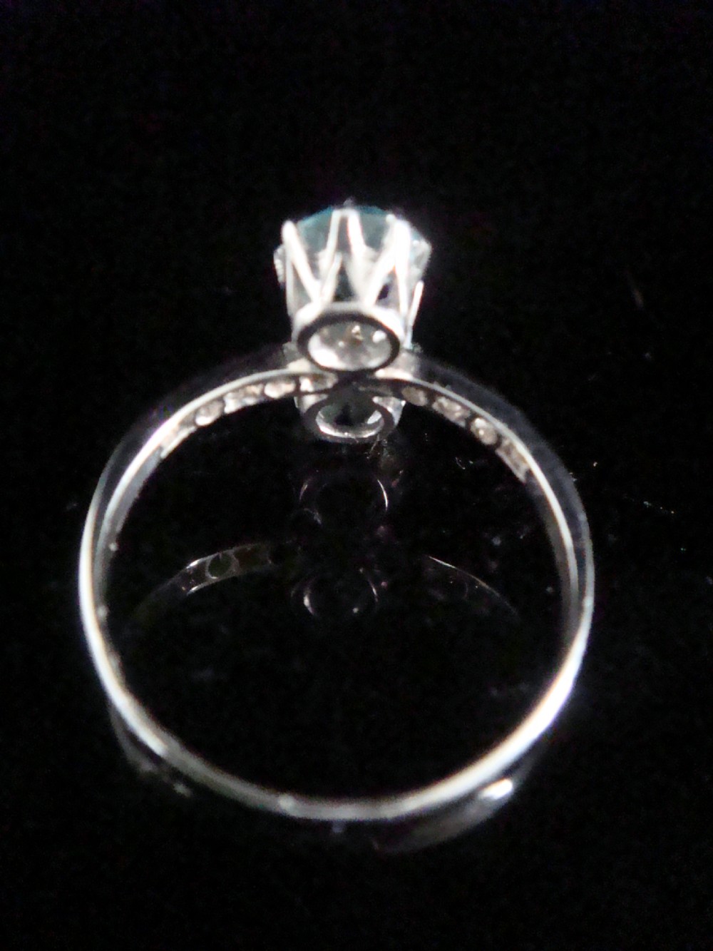 An Edwardian platinum ring featuring two round-cut blue zircon gemstones set vertically in a Toi et Moi design with diamond-set shoulders. View III
