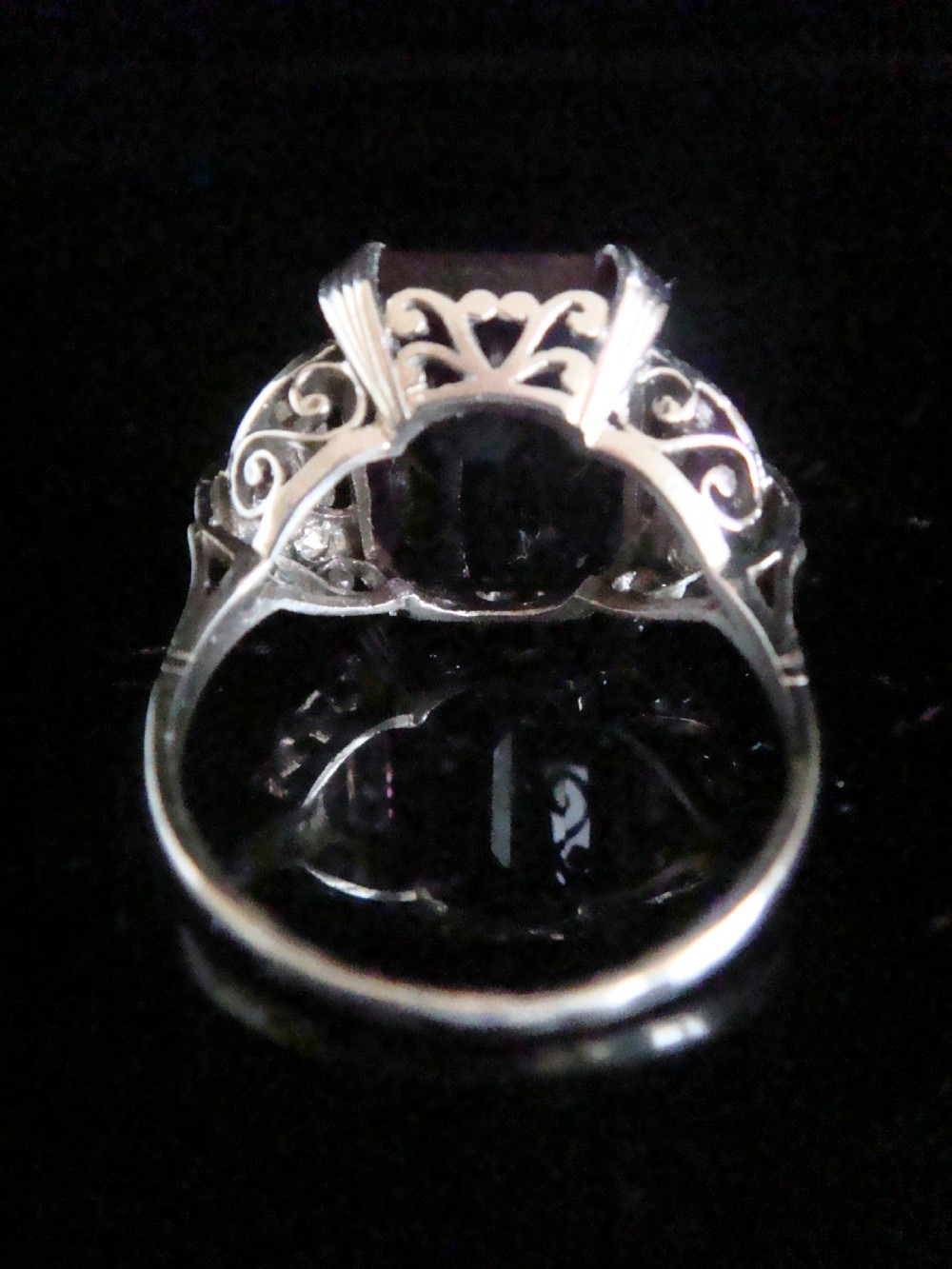An Art Deco cocktail ring featuring a large emerald-cut purple amethyst flanked by diamond-set shoulders in an 18ct white gold setting. View III