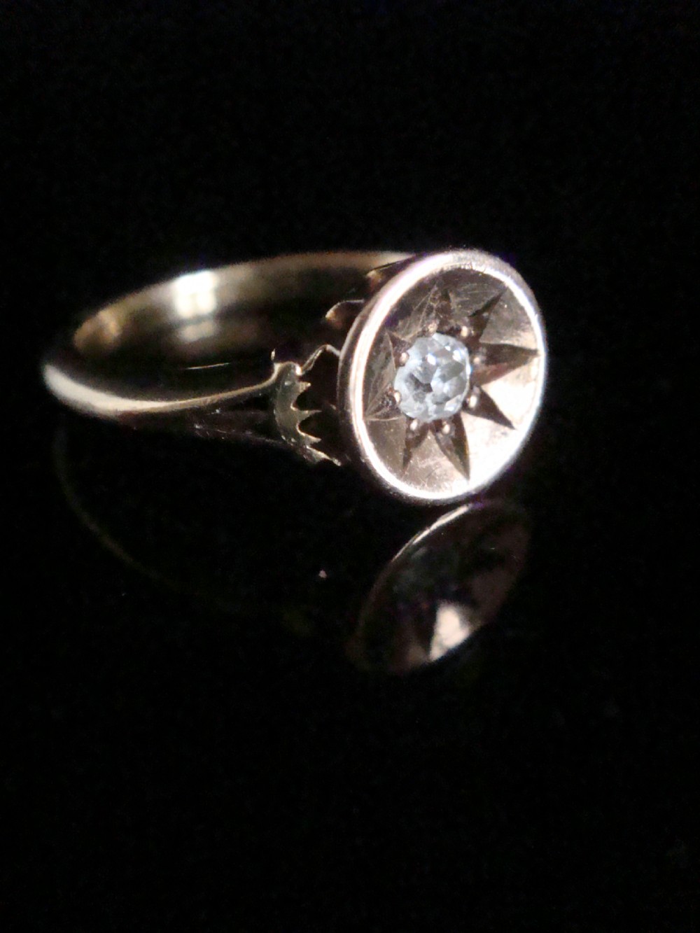 An 18ct yellow gold Victorian ring featuring a central starburst engraving with a single flush-set diamond. View III