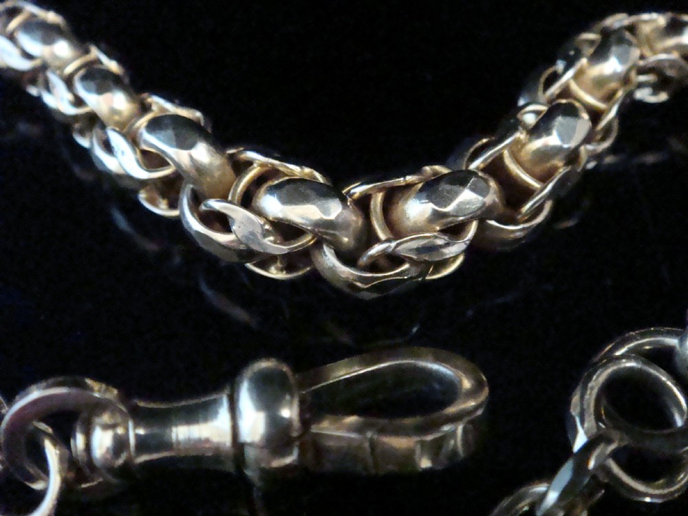 An Edwardian 9ct yellow gold graduated link chain bracelet featuring a swivel clasp and T-bar accent. View II