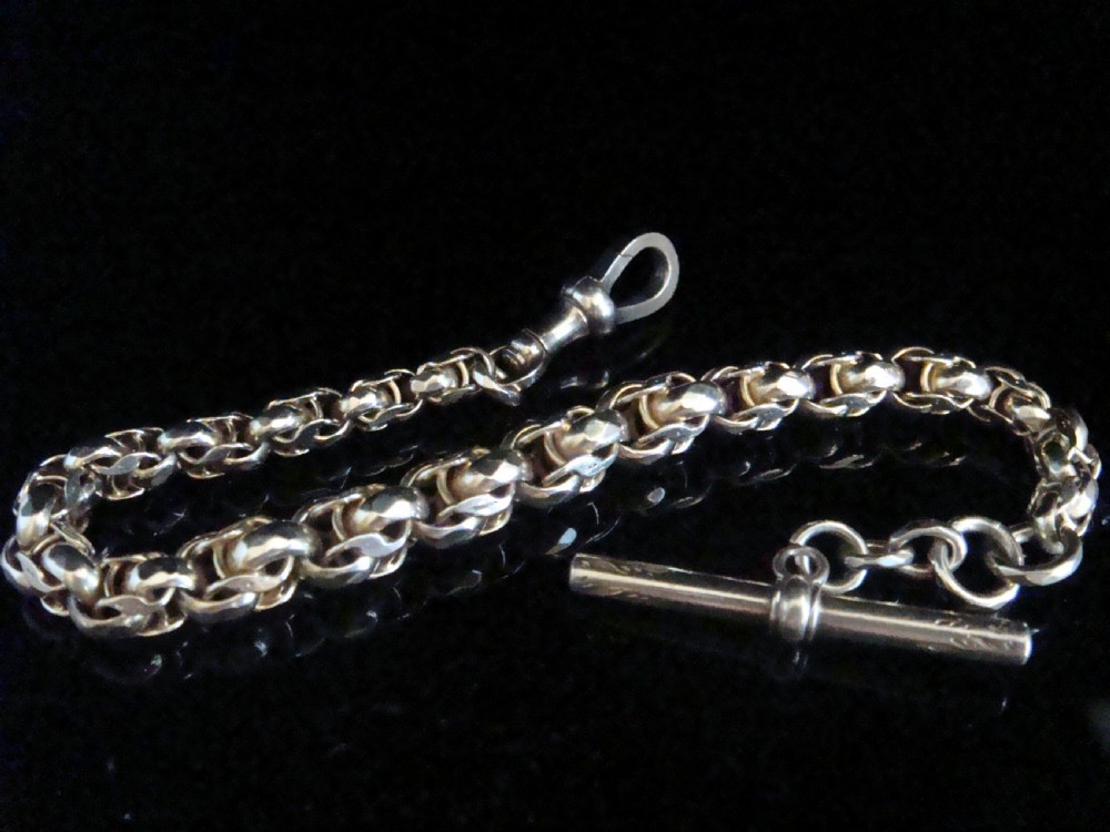 An Edwardian 9ct yellow gold graduated link chain bracelet featuring a swivel clasp and T-bar accent. View III