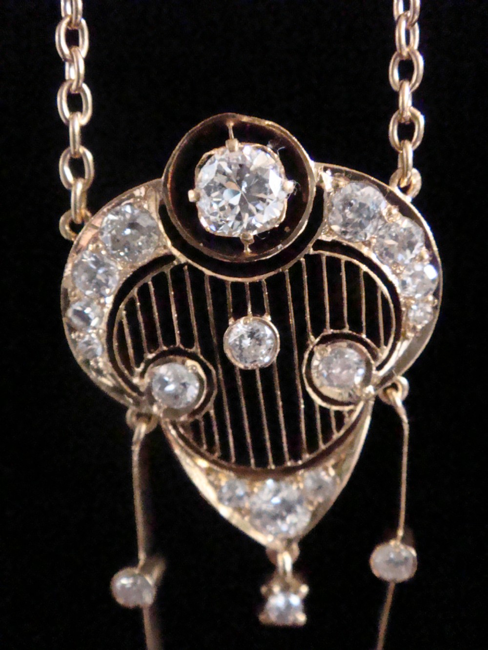 An ornate Victorian yellow gold pendant necklace set with round diamonds and black enamel accents, featuring two hanging diamond drop elements. View II