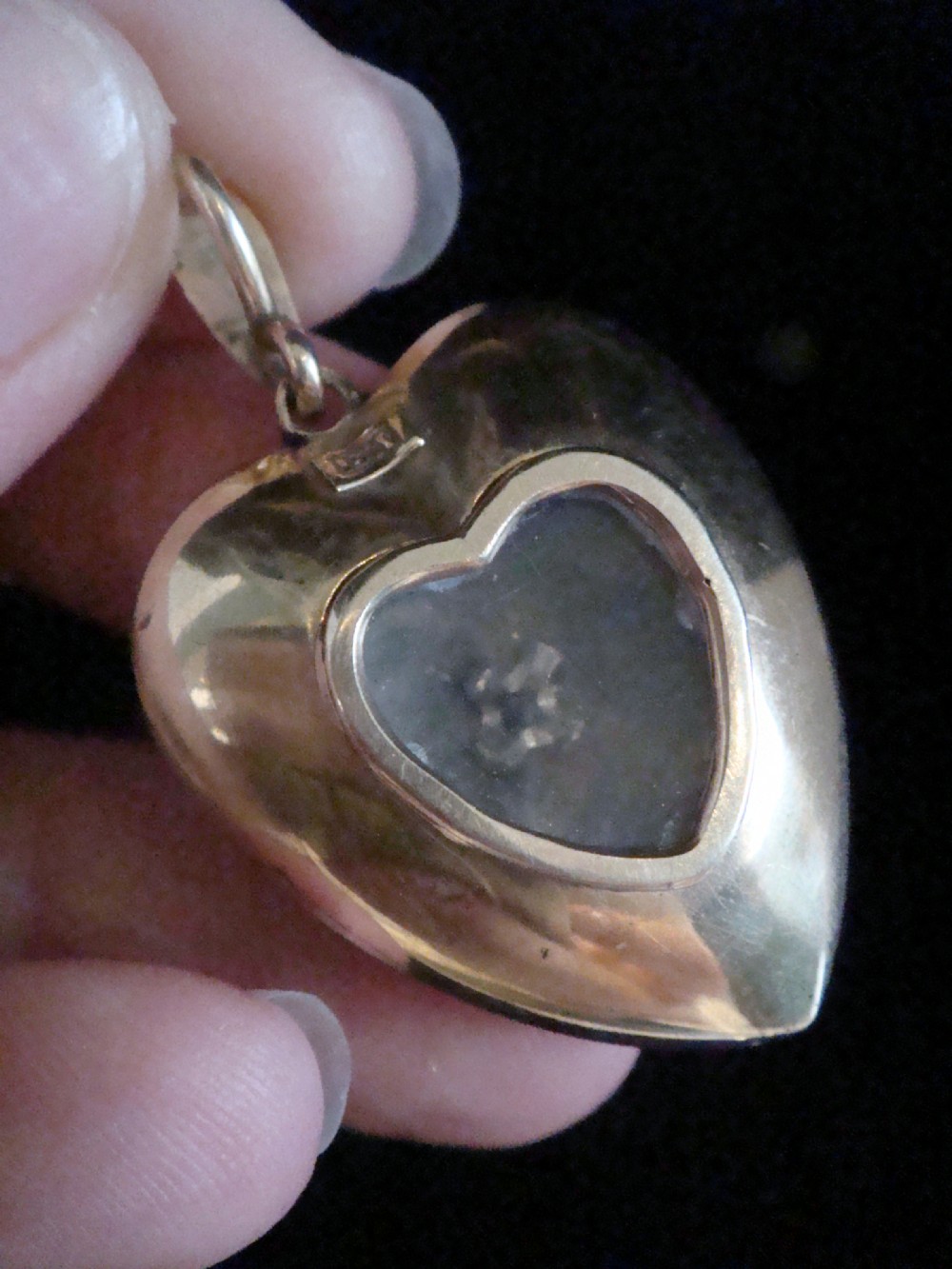 A Victorian heart-shaped pendant in cobalt blue guilloche enamel, accented by a central seed pearl and diamond star motif with a pearl-set gold bail. View IV
