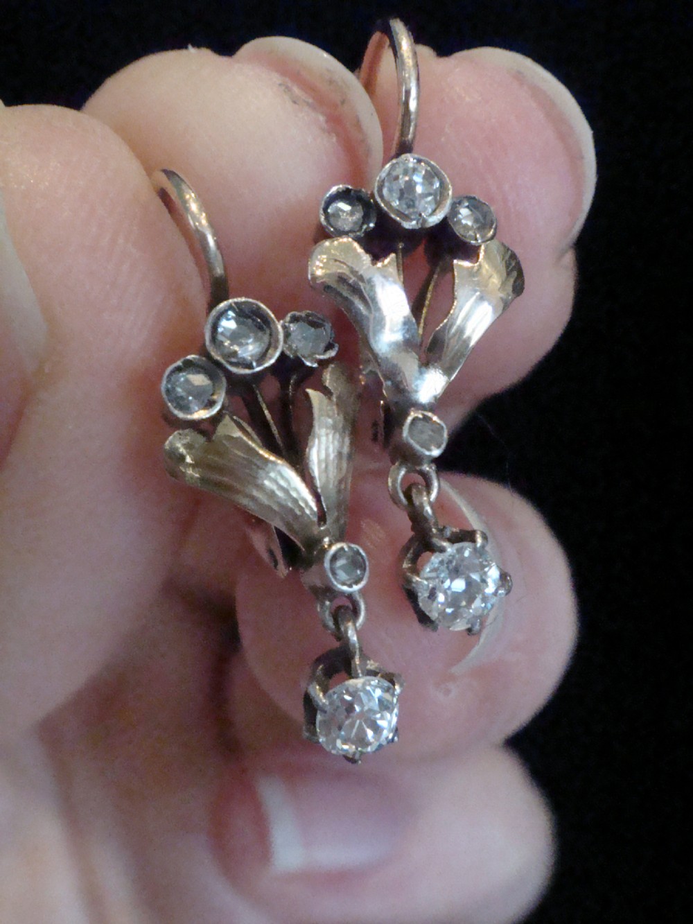A pair of French Edwardian 18ct yellow gold and platinum drop earrings with leaf motifs, set with rose cut diamonds and suspended round diamond drops. View III