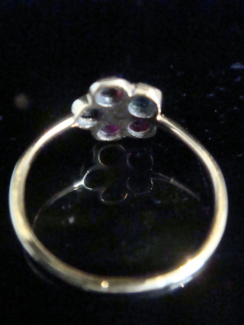 A Victorian 15ct gold flower cluster ring set with cabochon gemstones surrounding a central diamond. View V