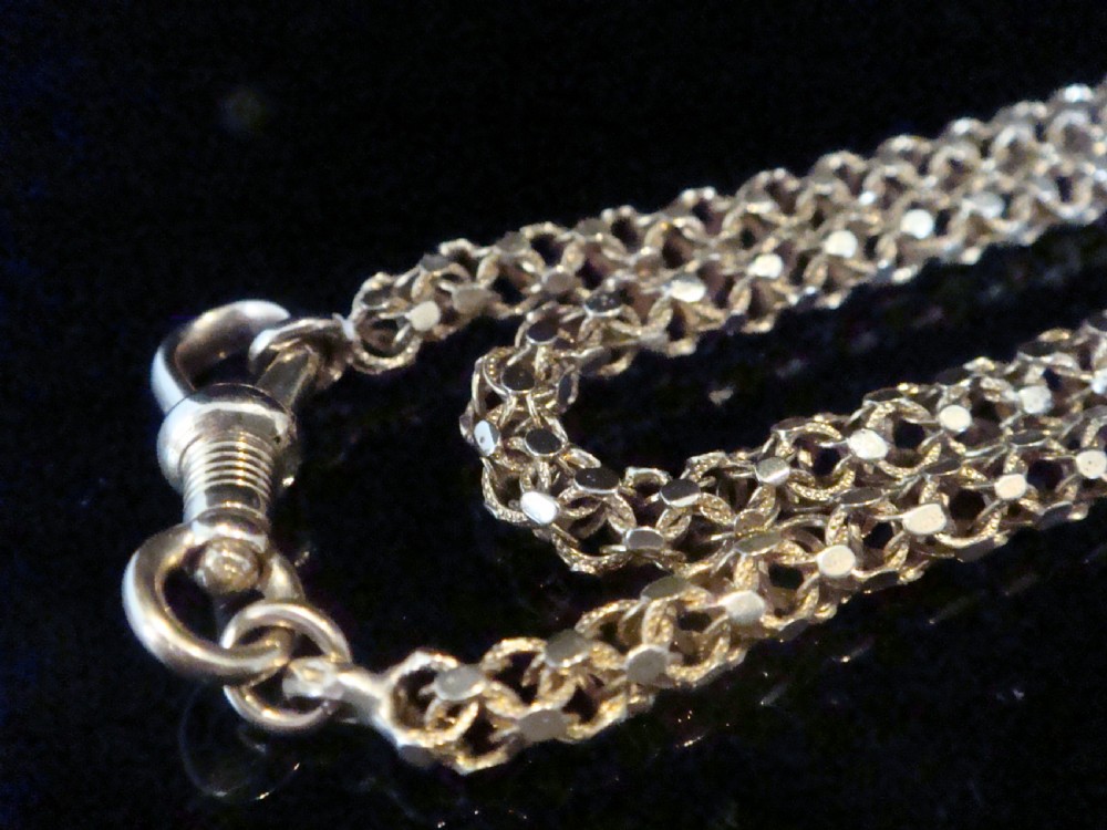 A close-up view of a Victorian 9ct yellow gold woven link chain featuring a dog clip fastener.