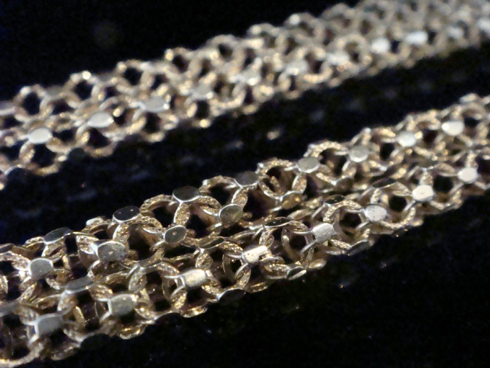 A close-up view of a Victorian 9ct yellow gold woven link chain featuring a dog clip fastener. View III