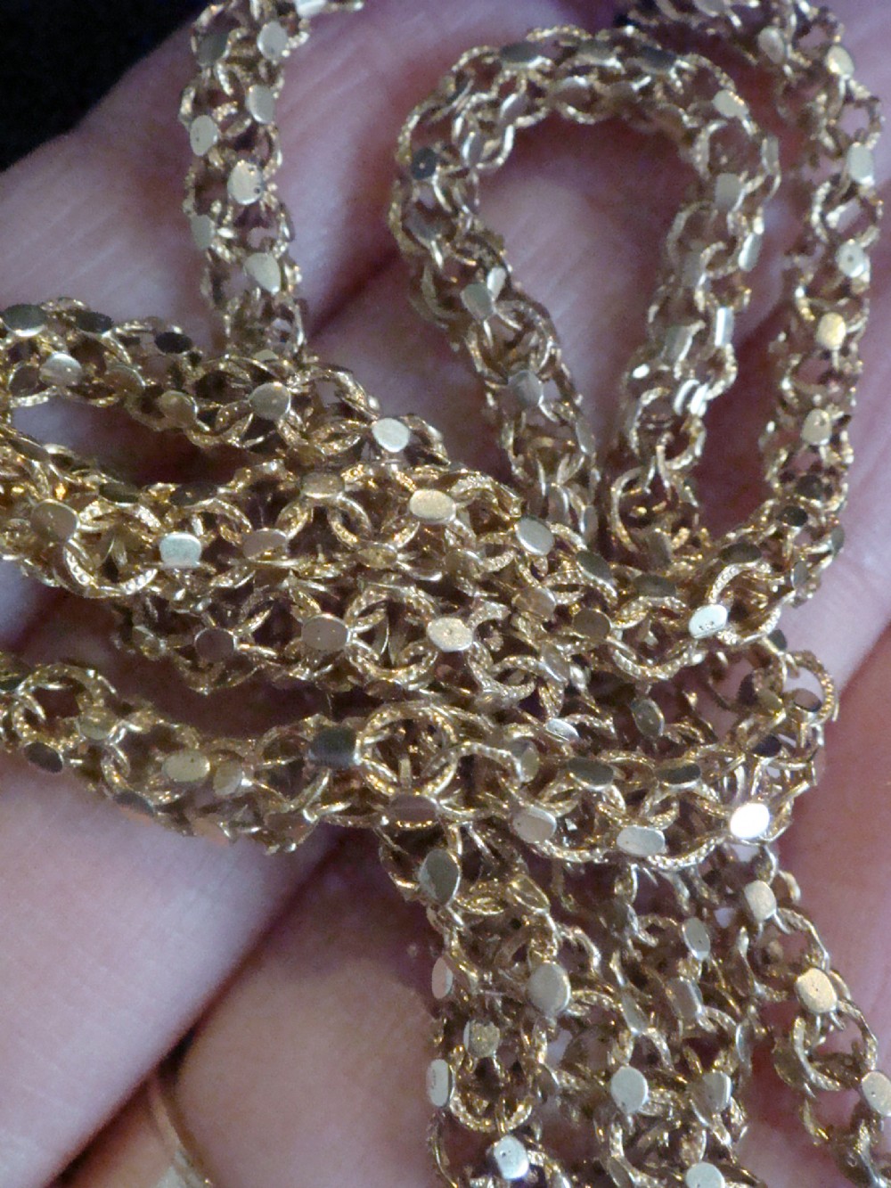 A close-up view of a Victorian 9ct yellow gold woven link chain featuring a dog clip fastener. View IV