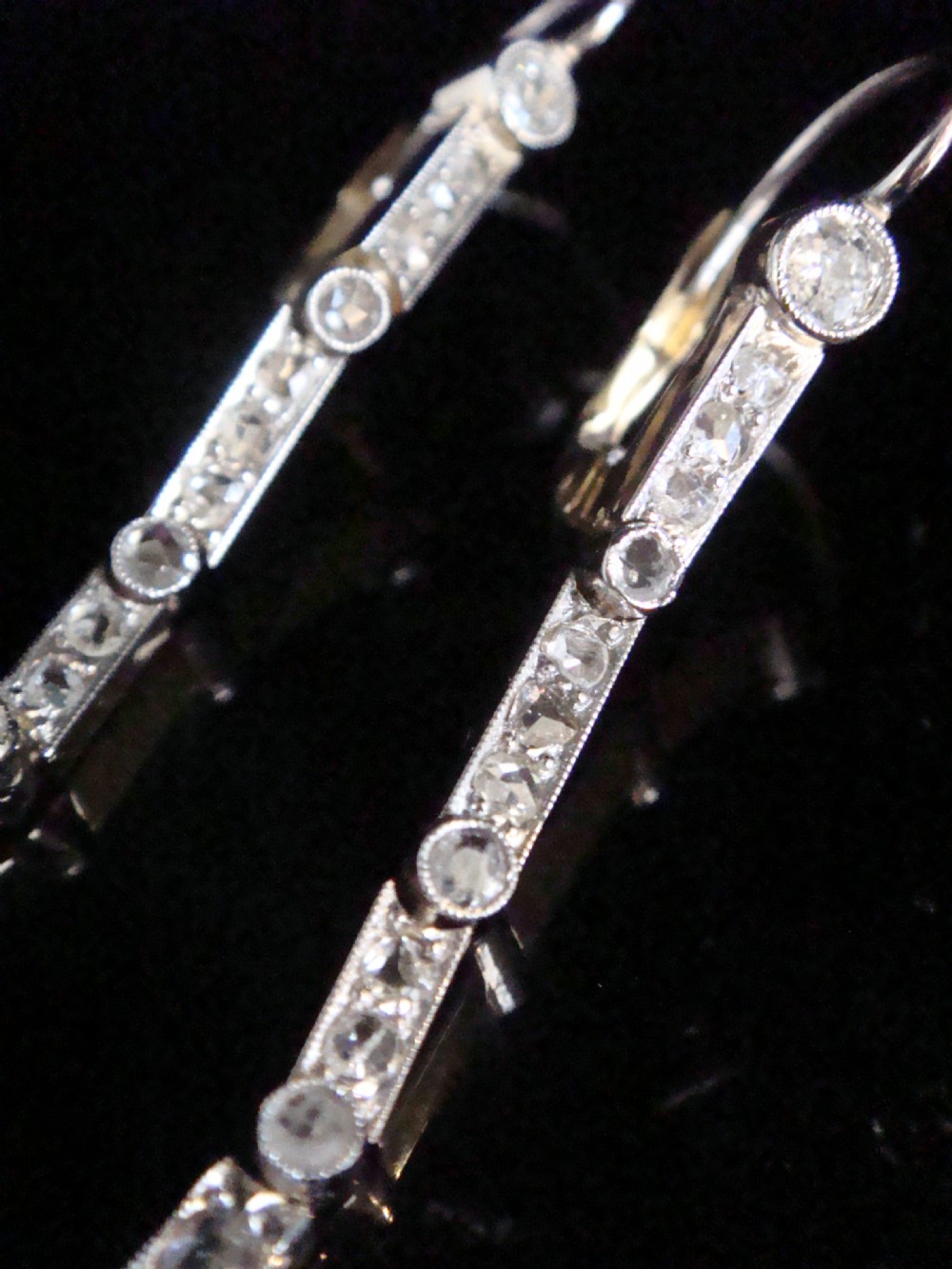 A pair of Edwardian drop earrings set in platinum featuring blue sapphires and old cut diamond floral clusters. View III