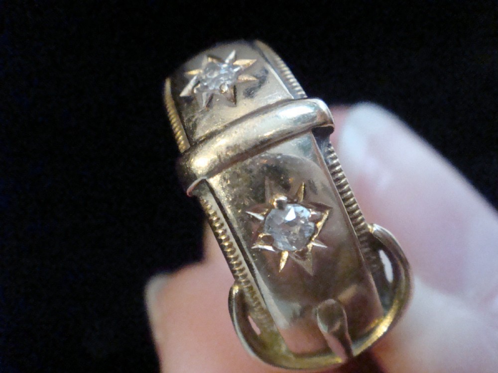 An 18ct yellow gold buckle ring with starburst-set diamonds along the strap. View II