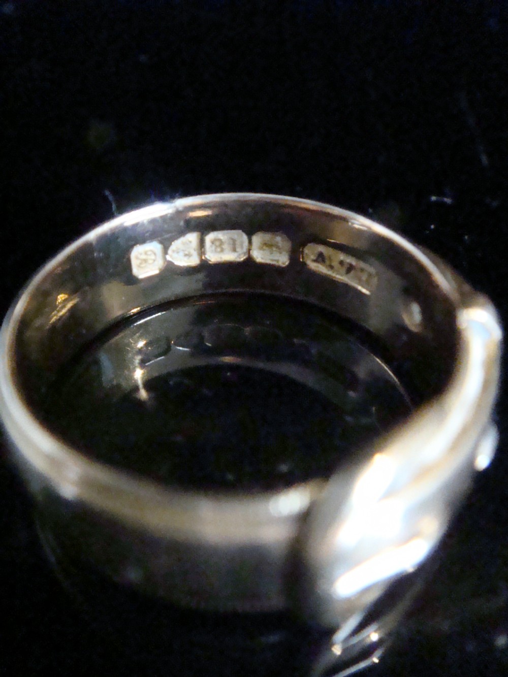 An 18ct yellow gold buckle ring with starburst-set diamonds along the strap. View III