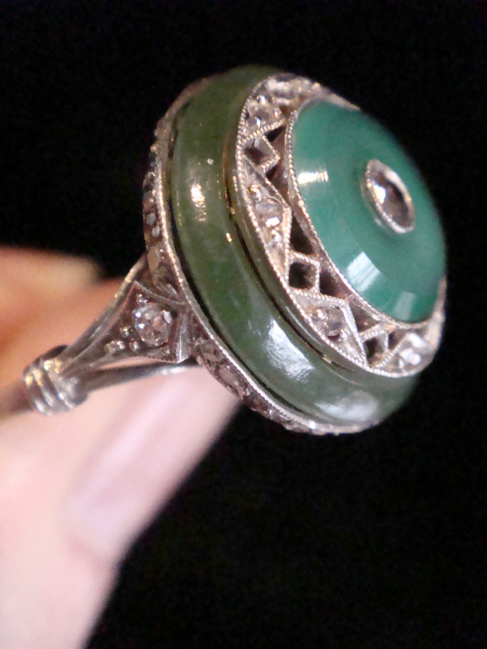 Circular Art Deco platinum target ring featuring a central old cut diamond surrounded by green chalcedony and milgrain pierced detailing. View IV