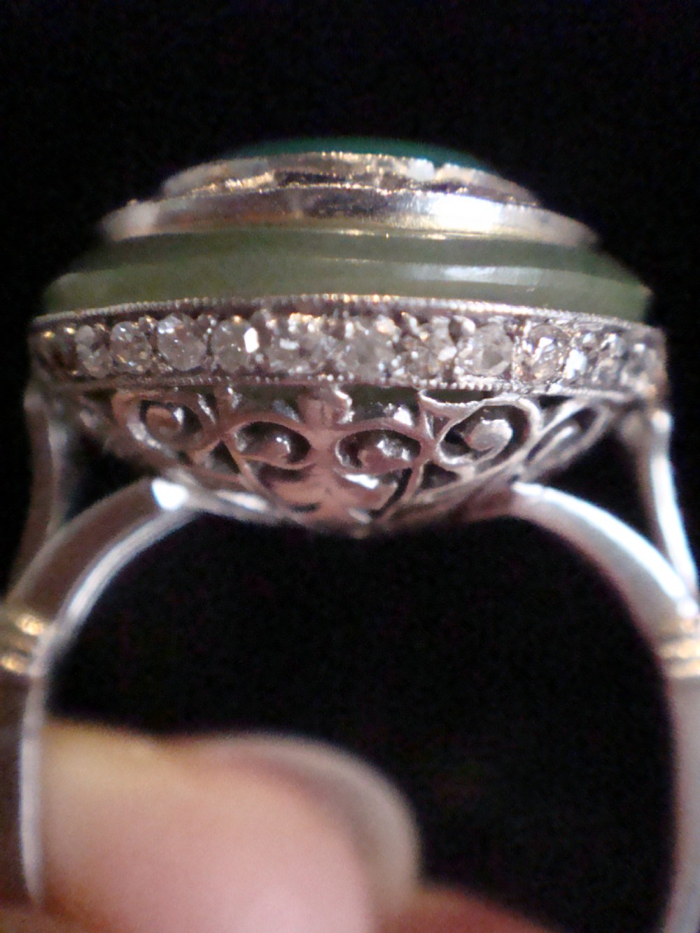 Circular Art Deco platinum target ring featuring a central old cut diamond surrounded by green chalcedony and milgrain pierced detailing. View V