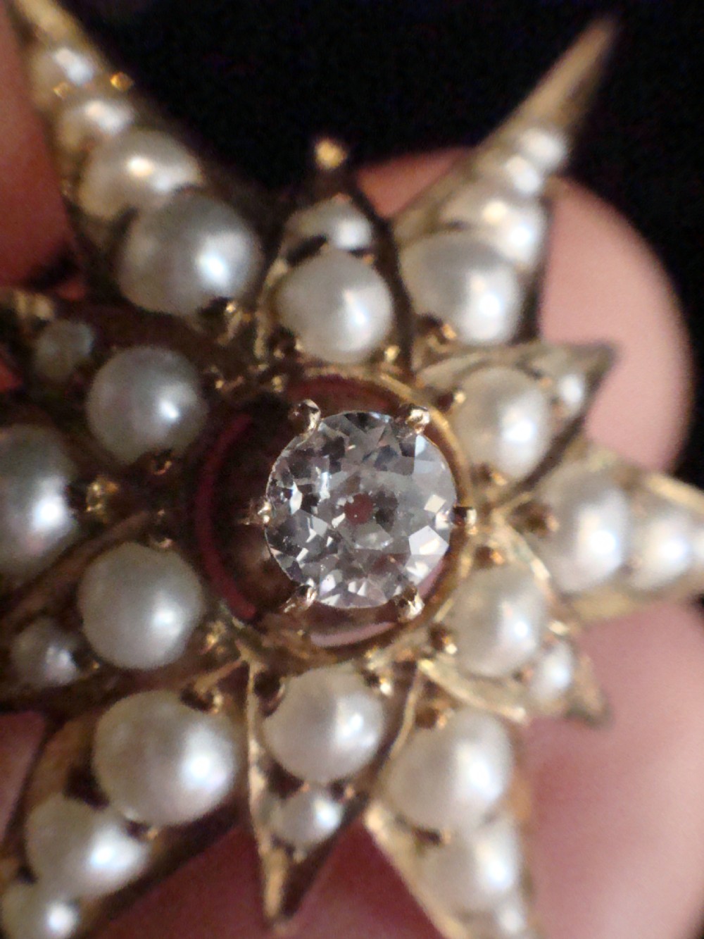 A Victorian 9ct yellow gold multi-pointed starburst pendant set with a central round diamond and graduated seed pearls along each ray. View III
