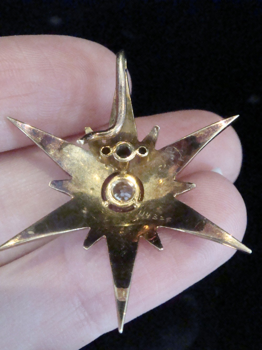 A Victorian 9ct yellow gold multi-pointed starburst pendant set with a central round diamond and graduated seed pearls along each ray. View IV