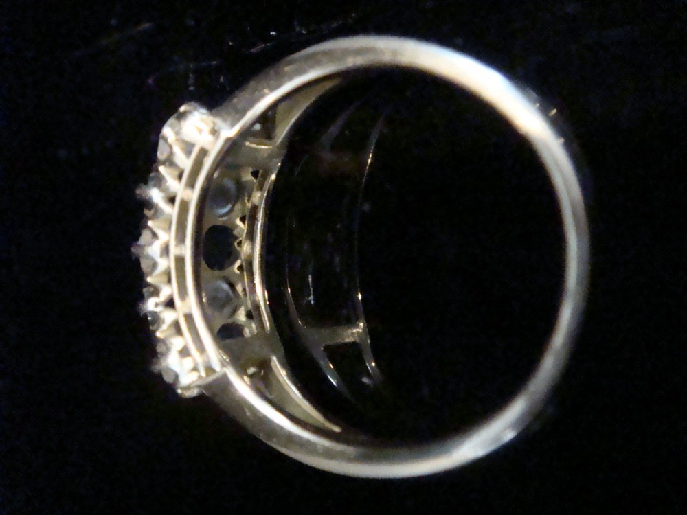 An Edwardian 18ct yellow gold ring set with two rows of alternating round blue sapphires and old-cut diamonds in a boat setting. View IV