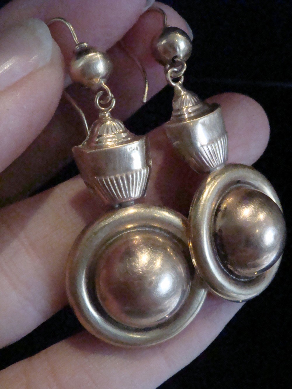 A pair of Victorian 9ct rose and yellow gold drop earrings featuring circular domed central motifs suspended from decorative top sections and shepherd hooks. View II