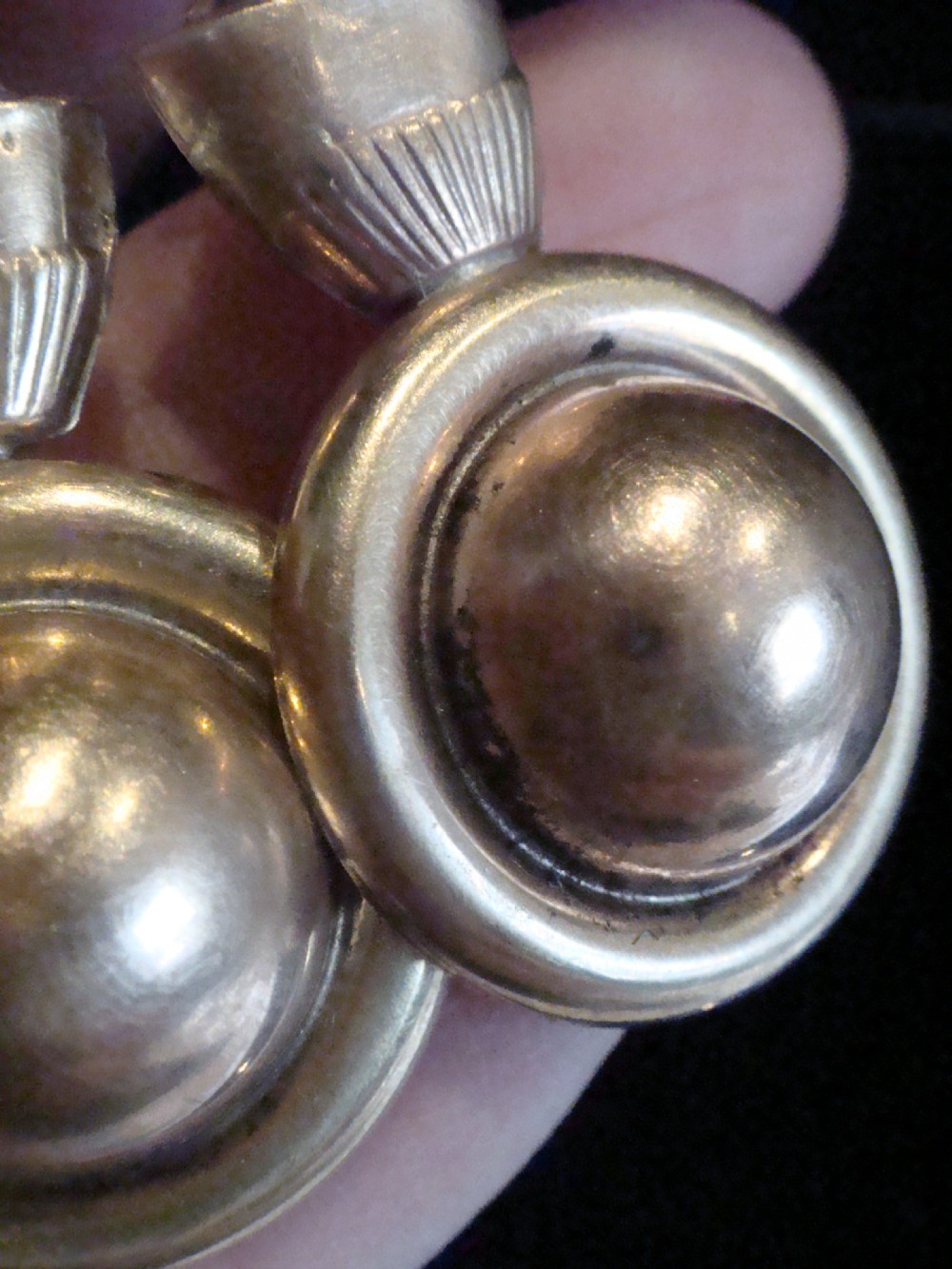 A pair of Victorian 9ct rose and yellow gold drop earrings featuring circular domed central motifs suspended from decorative top sections and shepherd hooks. View III