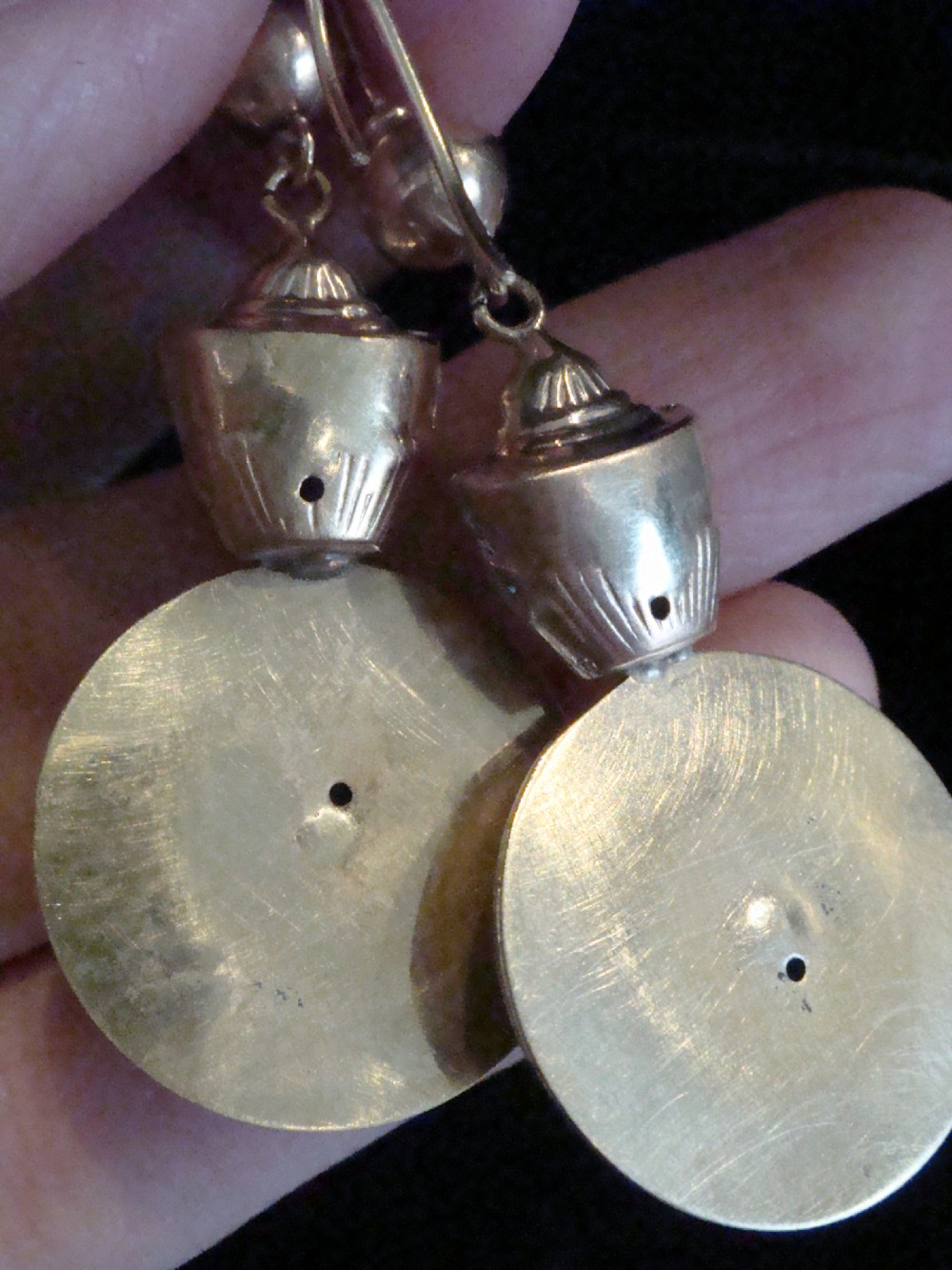 A pair of Victorian 9ct rose and yellow gold drop earrings featuring circular domed central motifs suspended from decorative top sections and shepherd hooks. View IV