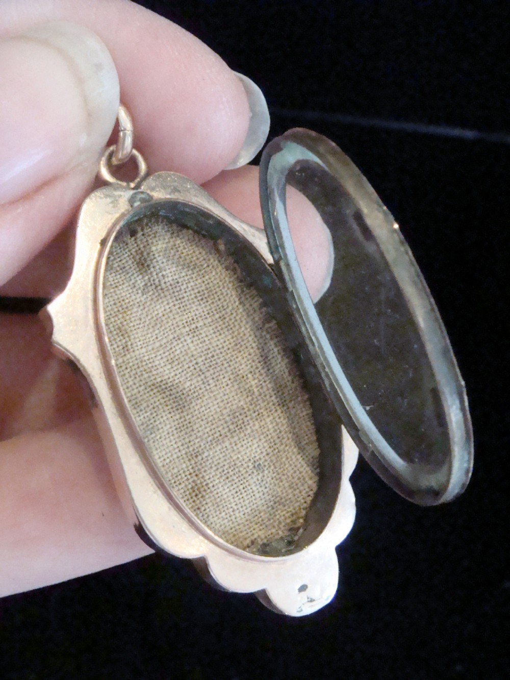 A Victorian rose gold locket featuring textured engine-turned patterning and a central leaf motif inset with small seed pearls. View II