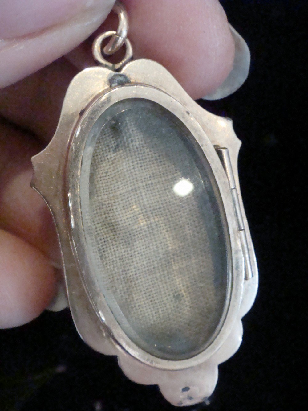 A Victorian rose gold locket featuring textured engine-turned patterning and a central leaf motif inset with small seed pearls. View III