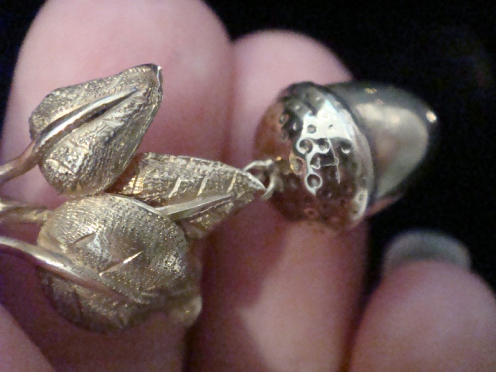 An Edwardian 9ct yellow gold drop pendant featuring textured oak leaves and a hanging acorn motif. View II
