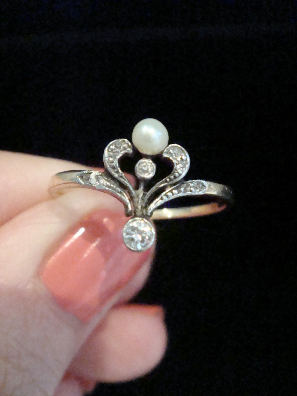 A French Edwardian 18ct gold and platinum ring featuring a central natural pearl set below a tiara motif with old-cut diamonds. View III