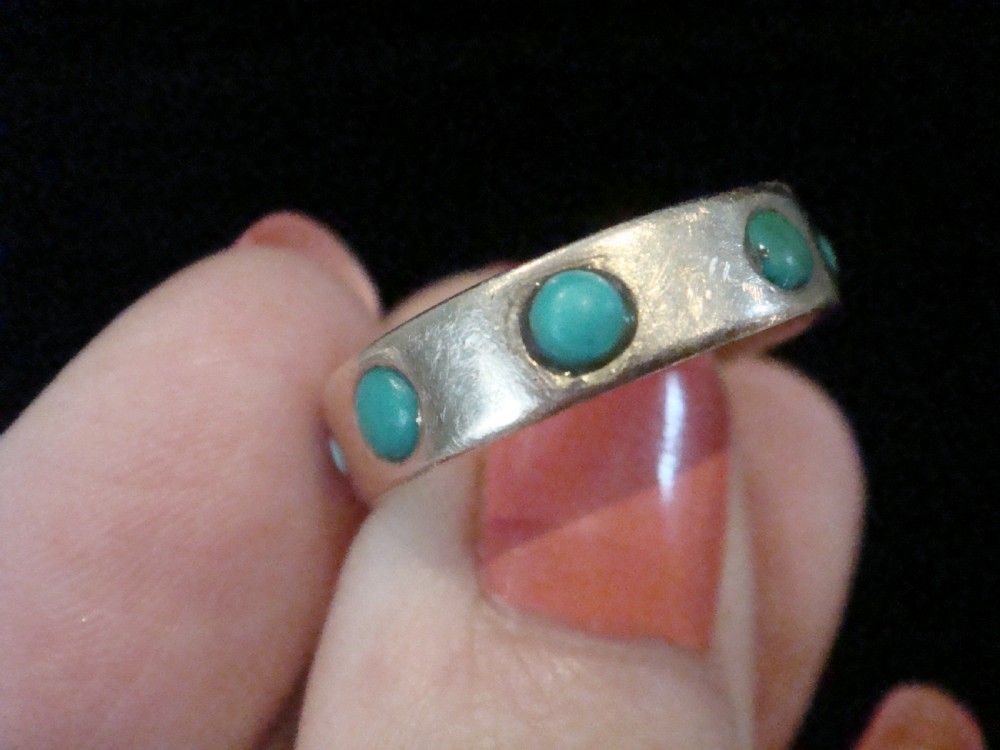 An Edwardian nine-carat rose gold full eternity ring set with smooth cabochon turquoise stones. View II