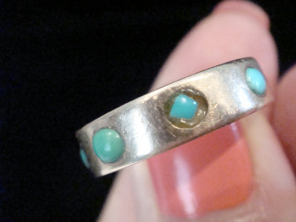 An Edwardian nine-carat rose gold full eternity ring set with smooth cabochon turquoise stones. View III