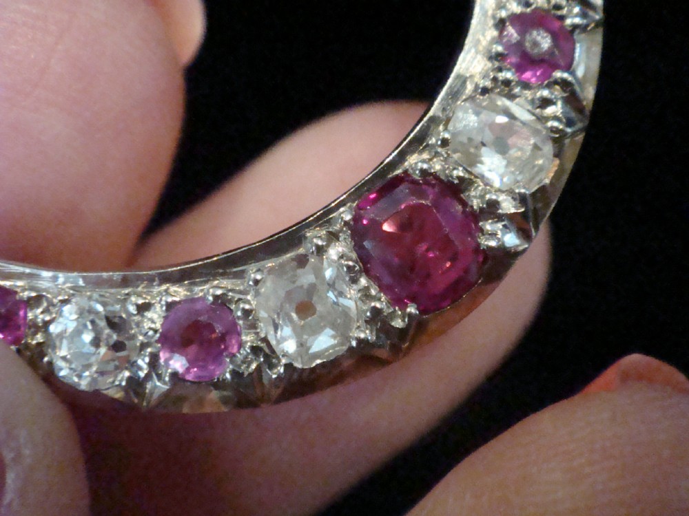 An Edwardian 18ct yellow gold crescent brooch featuring alternating natural red rubies and clear diamonds. View III