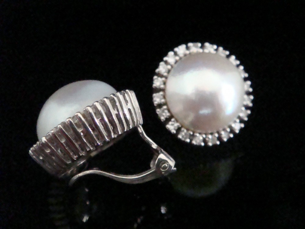 A pair of round Retro 14ct gold Mabe pearl cluster earrings encircled by a border of small brilliant-cut diamonds. View II