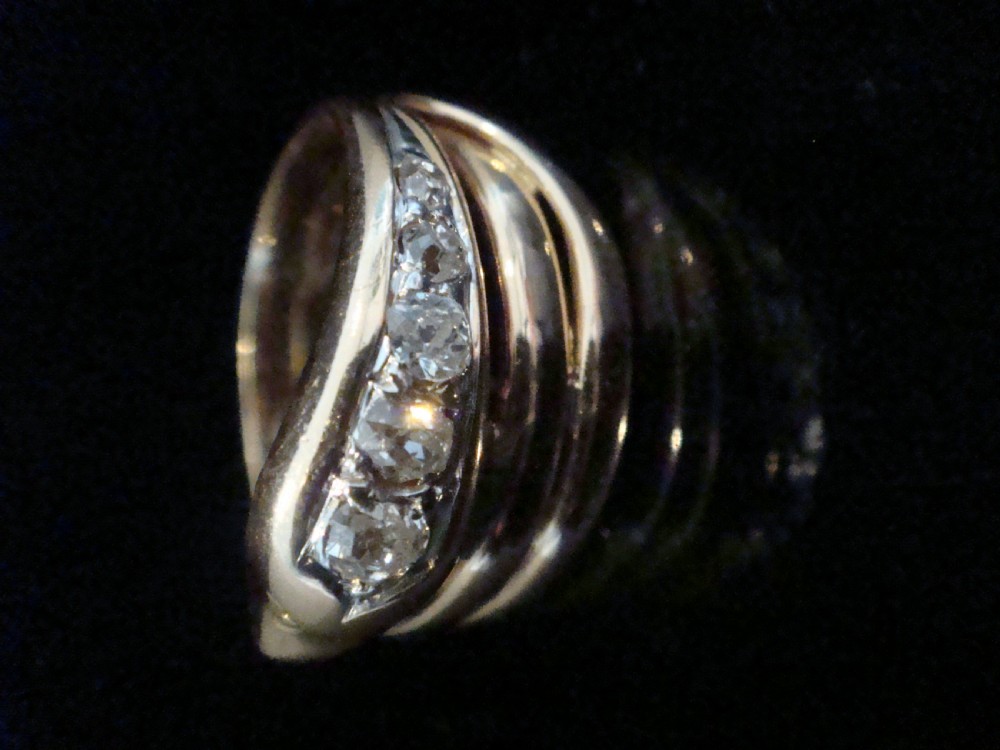 A Victorian 18ct gold snake ring featuring a coiled band set with a line of five graduated old cut diamonds along the serpent head. View III