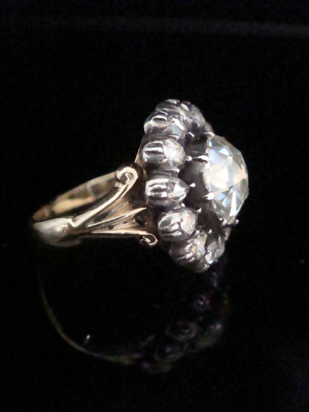 A Victorian 18ct yellow gold cluster ring featuring a central rose-cut diamond surrounded by a halo of smaller diamonds. View III