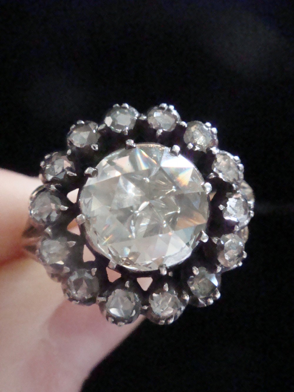 A Victorian 18ct yellow gold cluster ring featuring a central rose-cut diamond surrounded by a halo of smaller diamonds. View VII