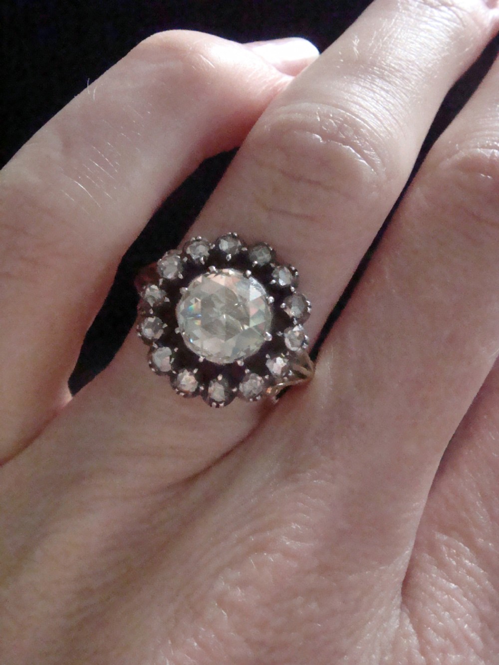 A Victorian 18ct yellow gold cluster ring featuring a central rose-cut diamond surrounded by a halo of smaller diamonds. View IX