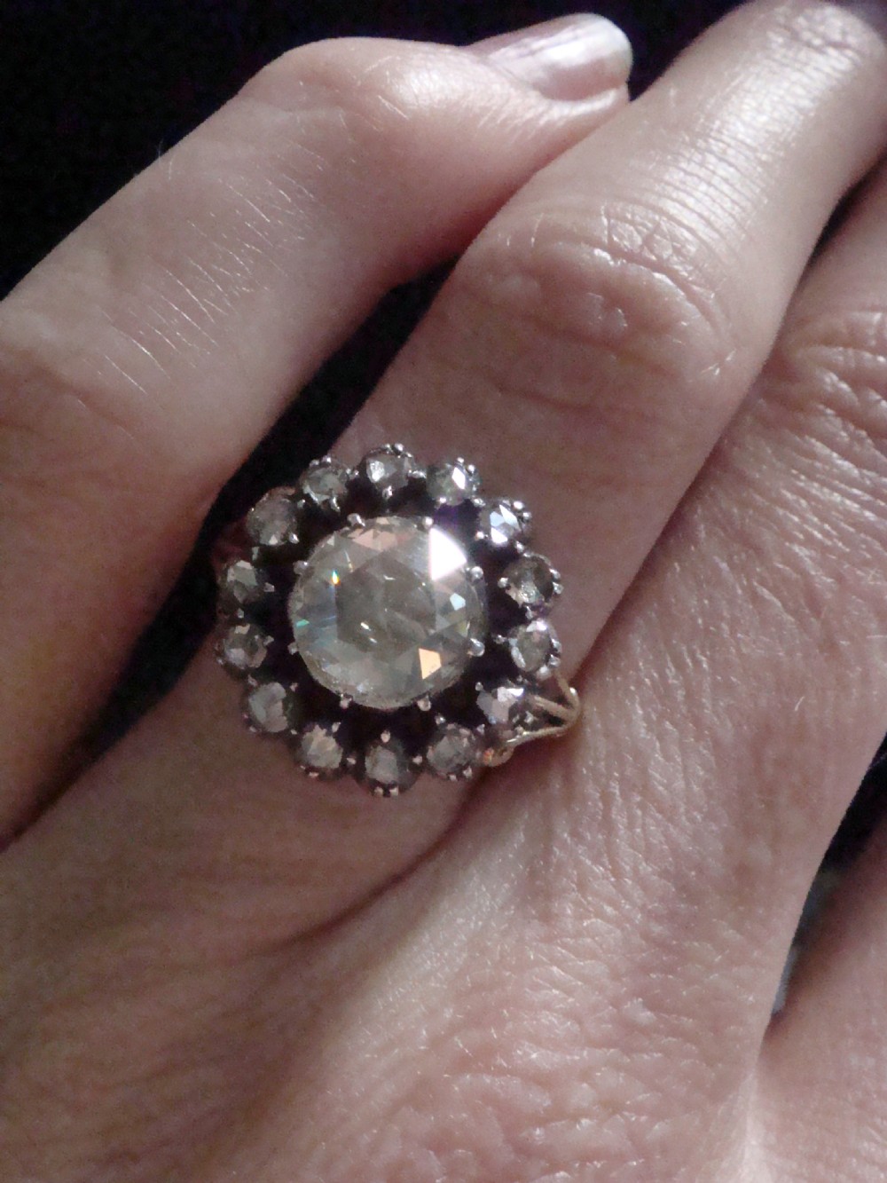 A Victorian 18ct yellow gold cluster ring featuring a central rose-cut diamond surrounded by a halo of smaller diamonds. View XII