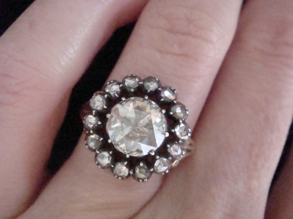 A Victorian 18ct yellow gold cluster ring featuring a central rose-cut diamond surrounded by a halo of smaller diamonds. View XIII