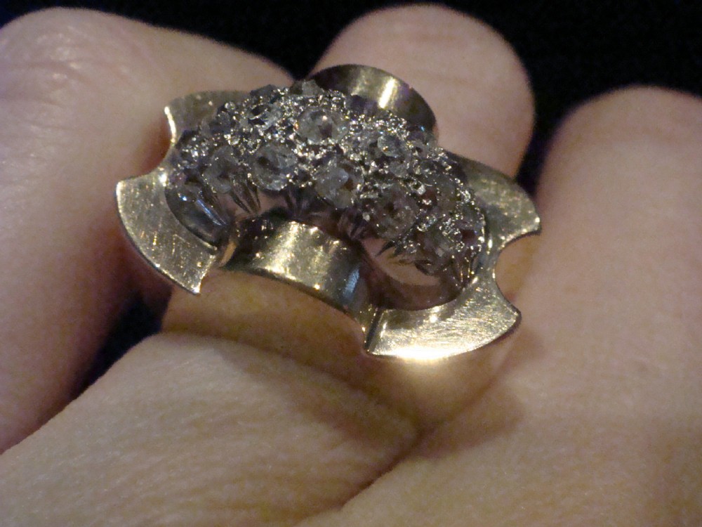 A French Retro Tank ring crafted in gold and platinum with a central pave-set diamond cluster. View IV