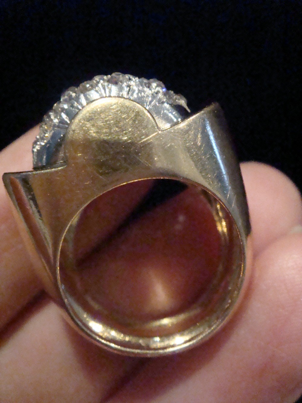 A French Retro Tank ring crafted in gold and platinum with a central pave-set diamond cluster. View VI